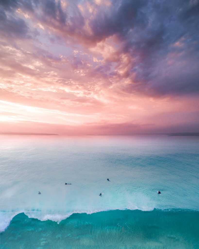birds eye view of people on beach during sunset